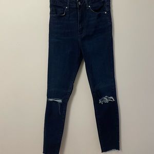 Dark wash ripped-knee skinny jeans